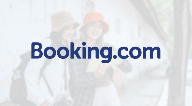Booking.com logo with two tourists behind