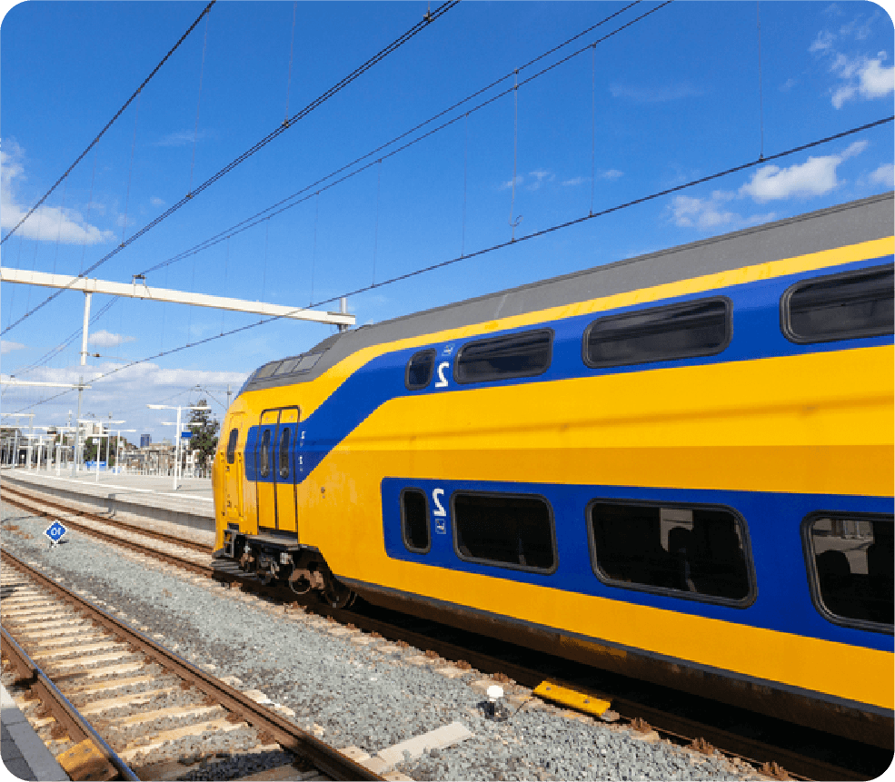 NS branded yellow and blue train departing station